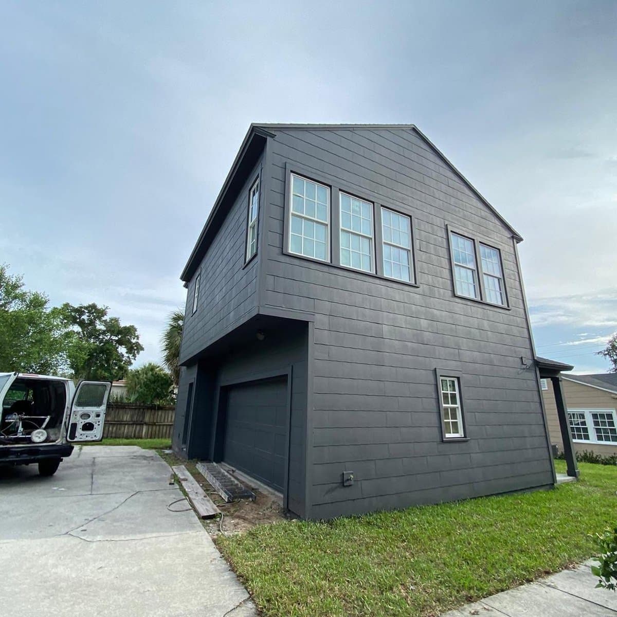 Dark gray exterior home painting - garage side