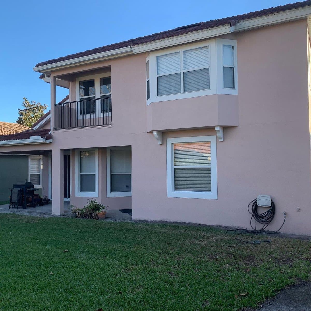 Stucco home exterior painting - backyard