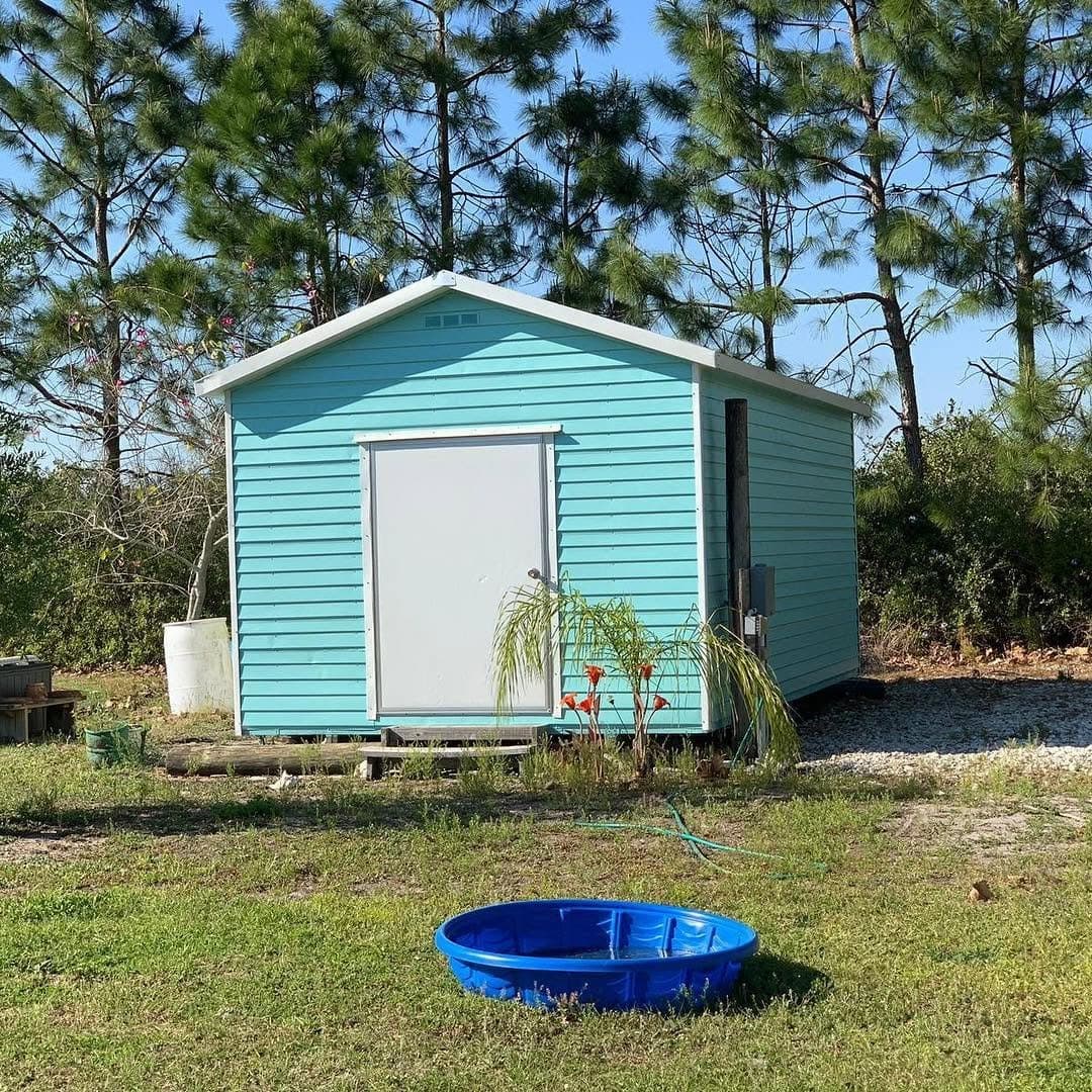 Shed after painting - turquoise finish front